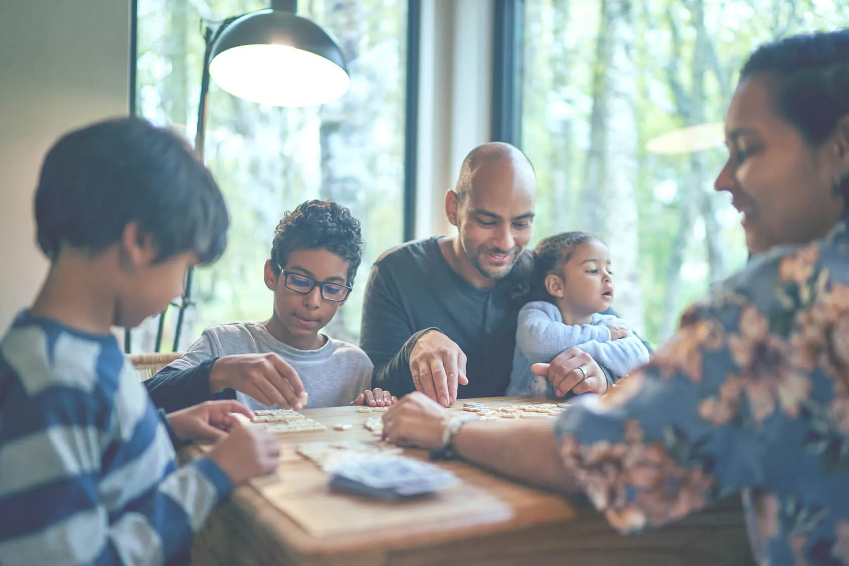 Family together at table having a game night